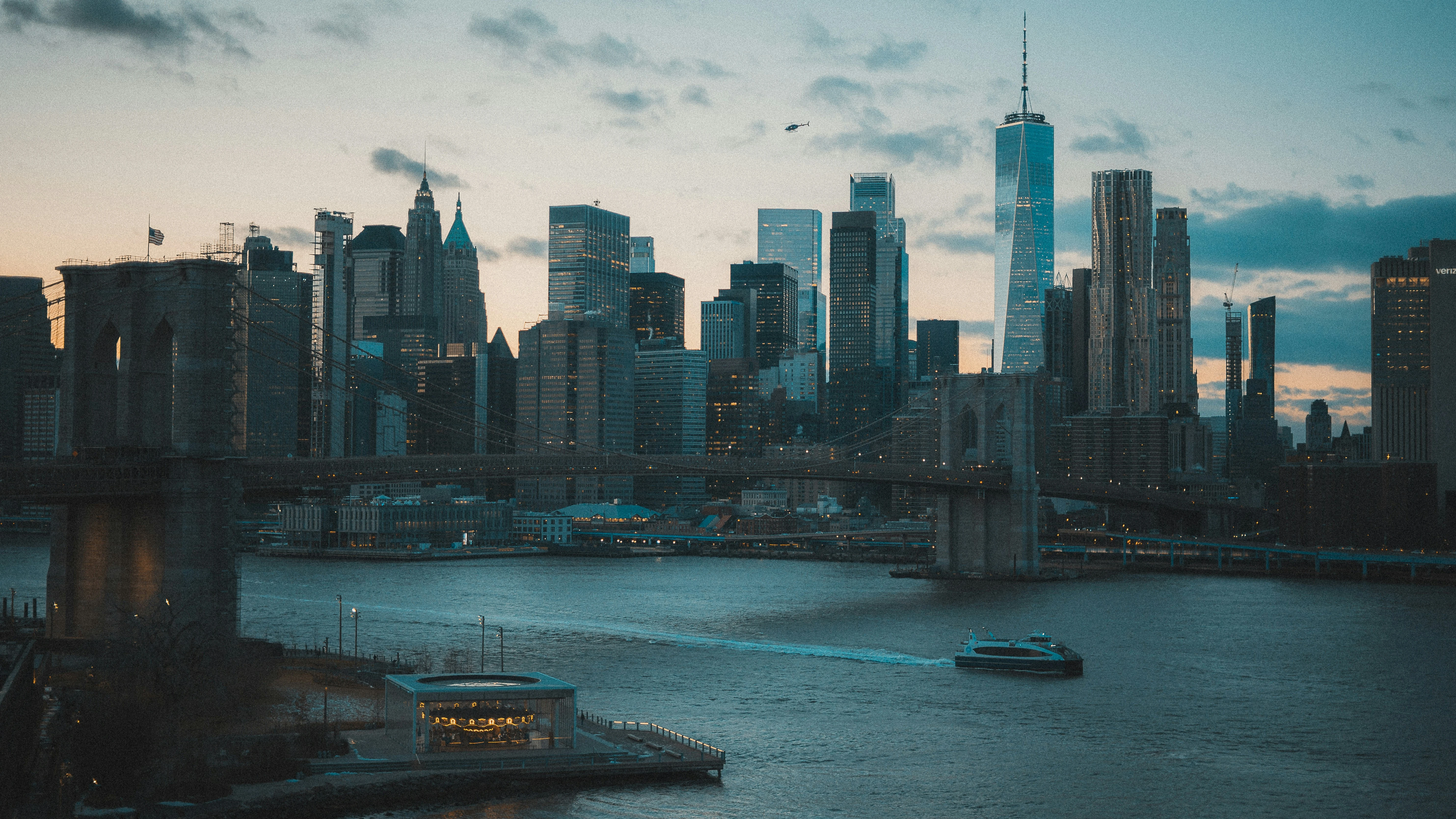 Brooklyn Bridge in NYC, with the skyline of the Financial District in the background.